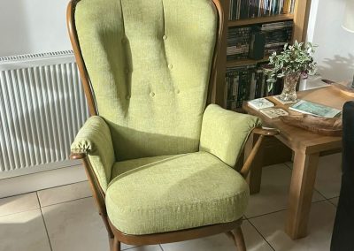 Pale green fabric covered armchair.